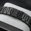 A close-up of a black watch band on a white surface. Produktbild-Vorschau
