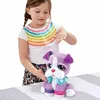 A young girl is interacting with a plush toy dog. Produktbild-Vorschau