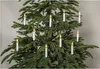 A close-up view of a Christmas tree decorated with white LED candle lights. Podgląd zdjęcia produktu