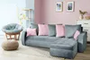 A living room scene with a sectional sofa, armchair, and ottoman. Produktbild-Vorschau
