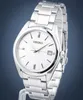 A close-up studio shot of a silver Seiko watch with a white face against a blue background. Náhľad obrázku produktu