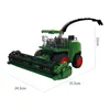 A green toy harvester with a black chute, shown from a three-quarter side view on a white background. Náhled obrázku produktu