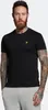 A man wearing a black t-shirt and grey sweatpants against a white background. Produktbild-Vorschau