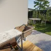 An outdoor sink and countertop setup next to a garden with a table and chairs. Náhľad obrázku produktu