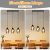 Two side-by-side images of a dining table with a pendant light fixture hanging above it. The left image shows the lights at a shorter height, and the right image shows them at a longer height. Produktbild-Vorschau
