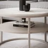 A close-up view of a two-tiered coffee table with decorative items and books on it. Náhľad obrázku produktu