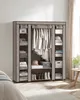 A fabric wardrobe with clothes and accessories organized inside, in a bedroom setting. Náhled obrázku produktu