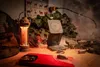 A tactical-themed setup with a lantern, wireless charger, phone, and firearm. Produktbild-Vorschau