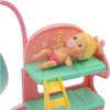 A close-up of a toy baby doll in a pink and green bunk bed set. Podgląd zdjęcia produktu