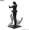 A figurine of a character from Hunter x Hunter, Chrollo Lucilfer, in a conductor's pose, with musical notes and sheets of music as part of the base. Produktbild-Vorschau