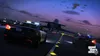 Two police cars are on an airport runway at dusk, with a jet airplane in the background. Produktbild-Vorschau