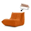 An orange beanbag chair is shown on a white background, with a rolled-up item and boxes in the upper right corner, and an arrow pointing from the rolled-up item to the chair. Náhľad obrázku produktu
