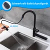 A black kitchen faucet with a pull-down sprayer is shown in use over a double stainless steel sink. Produktbild-Vorschau