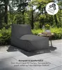 An outdoor patio with a dark gray bean bag chair and a small side table with drinks and a plant. Produktbild-Vorschau