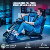 A man is sitting in a racing simulator cockpit, holding the steering wheel. Produktbild-Vorschau