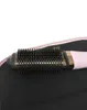 A close-up of a pink and gold hair dryer brush on a black surface. Produktbild-Vorschau