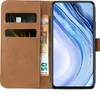 A brown leather flip case for a smartphone, showing the inside with card slots and a banknote, and the smartphone screen displaying a colorful wallpaper. Produktbild-Vorschau