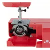 Close-up view of the bobbin area of a red sewing machine. Náhľad obrázku produktu
