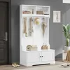 A white hall tree with a bench and storage cabinets, decorated with a few items, is shown in a room with a gray wall and a dark door. Anteprima dell’immagine prodotto