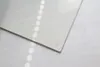 A close-up of the corner of a clear glass plate with a small clear bumper on the corner, resting on a white surface with reflections. Náhľad obrázku produktu