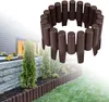 A garden border made of brown plastic palisades is installed along a raised garden bed and lawn. Náhled obrázku produktu