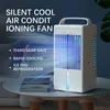 A white portable air cooler with blue lights is shown on a table next to books. The image has text overlays highlighting its features. Produktbild-Vorschau