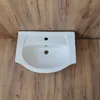 A white ceramic sink is shown from a top-down perspective, placed against a wooden plank background. Anteprima dell’immagine prodotto