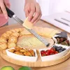 A person is grating cheese onto a wooden serving platter that holds crackers, almonds, cherry tomatoes, blueberries, and dried fruit. Náhľad obrázku produktu
