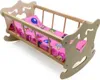 A wooden doll cradle with pink bedding. Náhľad obrázku produktu