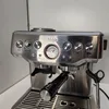 Close-up of the control panel and portafilter of a silver espresso machine. Produktbild-Vorschau