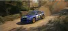 A blue rally car driving on a dirt road, kicking up dust. Podgląd zdjęcia produktu