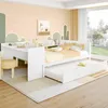 A bedroom scene featuring a white daybed with a pull-out trundle bed, decorated with yellow and white bedding and pillows. The room has a whimsical wallpaper with green and peach abstract shapes and small yellow triangles. A window with yellow curtains is  Voir les images du produit