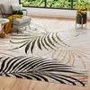 A living room scene with a rug, armchair, and plant. Náhľad obrázku produktu