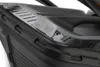 A close-up view of a black lawnmower with a small clear plastic accessory attached to the top. Produktbild-Vorschau