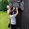 An older man and a younger boy are playing darts outdoors. Náhľad obrázku produktu