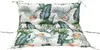 A close-up, front-facing view of a tufted cushion with a tropical leaf and flower pattern. Produktbild-Vorschau