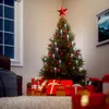 A decorated Christmas tree with presents underneath, in a room with a window and a framed picture on the wall. Náhled obrázku produktu