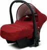A red baby car seat with a black handle and base, shown from a diagonal angle against a white background. Náhled obrázku produktu