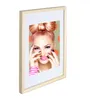 A framed picture of a woman with vibrant makeup and hair. Produktbild-Vorschau