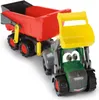 A toy tractor with a trailer, shown from a slightly elevated front-left angle against a white background. Produktbild-Vorschau