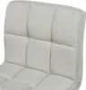A close-up view of the quilted fabric texture of a beige bar stool. Náhled obrázku produktu