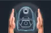 Two hands are shown on either side of a vacuum cleaner, which is outlined in a blue glow, suggesting a protective or advanced feature. Voir les images du produit