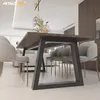 A modern dining room with a large wooden table and gray chairs. Produktbild-Vorschau