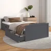 A dark gray wooden bed with drawers, made up with bedding and a blanket, placed on a rug in a room. Náhľad obrázku produktu