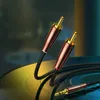 A close-up shot of UGREEN audio cables with RCA and 3.5mm jack connectors, placed on a vinyl record. Náhled obrázku produktu