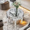 A mirrored coffee table with a vase of flowers and books on a plush rug. Anteprima dell’immagine prodotto
