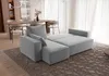 A modern living room with a light grey sectional sofa and a dining area in the background. Produktbild-Vorschau