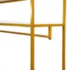 A close-up view of a gold metal clothing rack with white shelves. Podgląd zdjęcia produktu