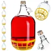 A collection of glass carboys, one filled with red liquid and a yellow protective base, and others empty. Produktbild-Vorschau