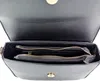 The inside of an open black handbag with zippered compartments. Produktbild-Vorschau